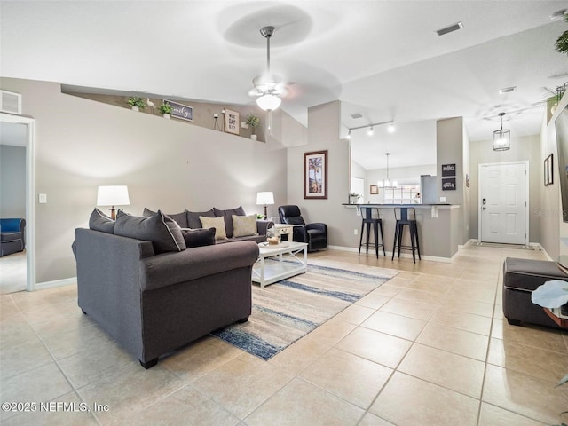 tiled living room with ceiling fan and lofted ceiling