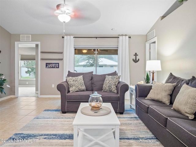 tiled living room featuring ceiling fan