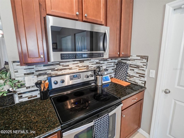 kitchen with decorative backsplash, stainless steel appliances, and dark stone counters