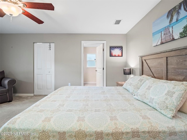 carpeted bedroom featuring a closet, ceiling fan, and ensuite bathroom