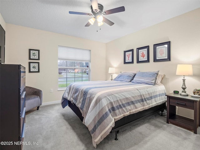 bedroom featuring light carpet and ceiling fan