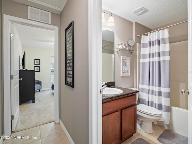 full bathroom with tile patterned flooring, vanity, toilet, a textured ceiling, and shower / bath combo with shower curtain