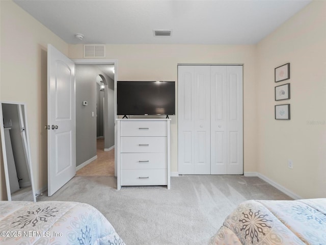 carpeted bedroom featuring a closet