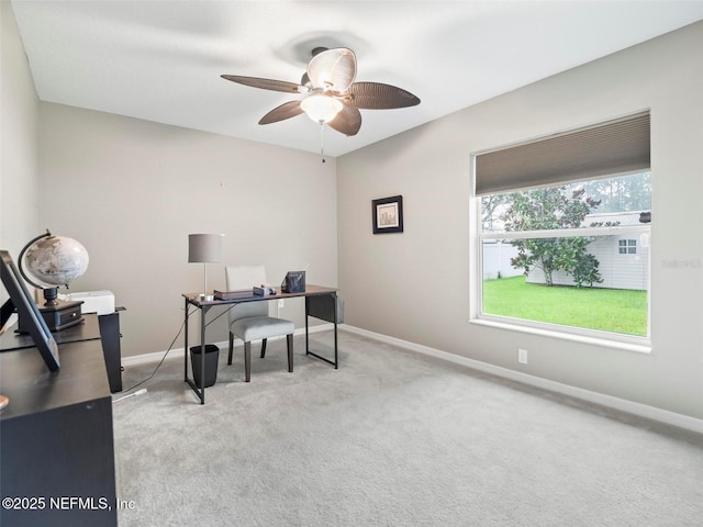 carpeted office featuring ceiling fan