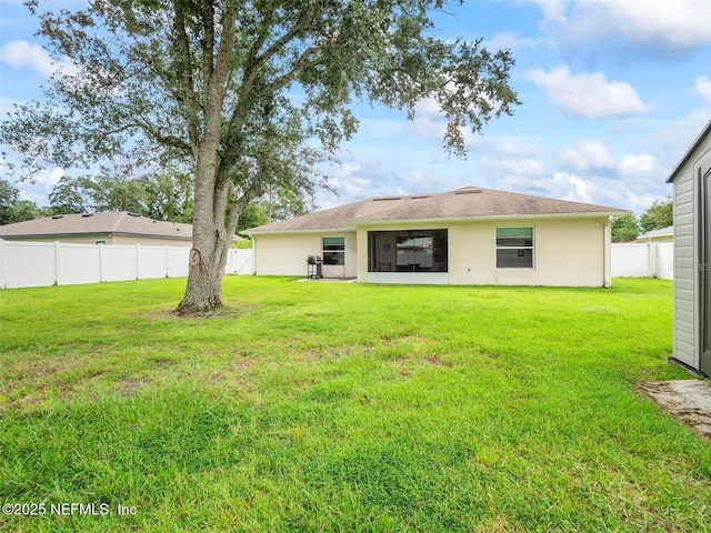 back of property with a lawn