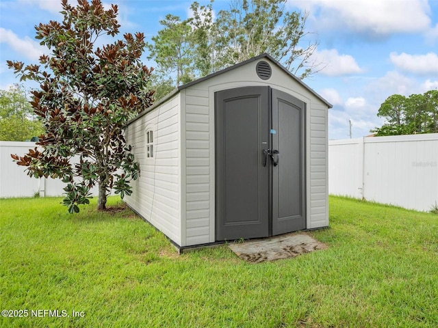 view of outdoor structure with a lawn