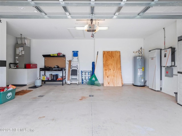 garage featuring a garage door opener, electric water heater, and heating unit