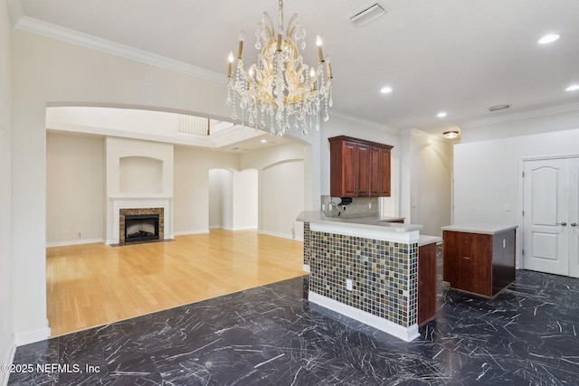 kitchen with ornamental molding, pendant lighting, and kitchen peninsula