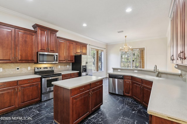 kitchen featuring sink, decorative light fixtures, a center island, appliances with stainless steel finishes, and backsplash