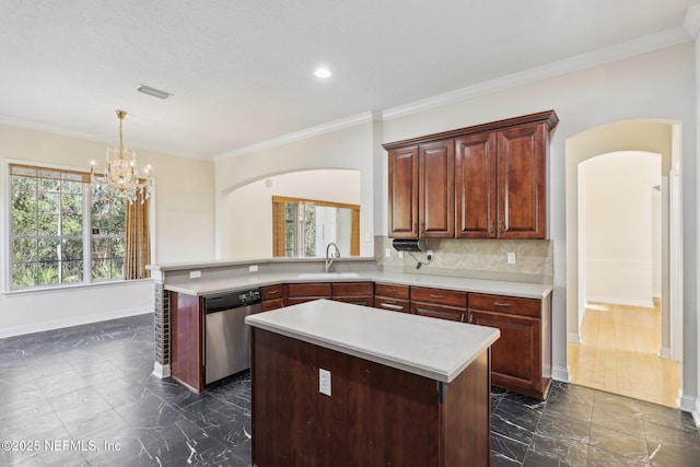 kitchen featuring sink, kitchen peninsula, dishwasher, a kitchen island, and backsplash