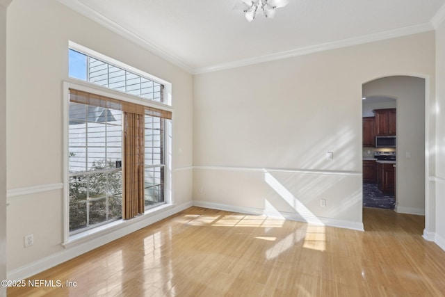 unfurnished room featuring crown molding and light hardwood / wood-style flooring