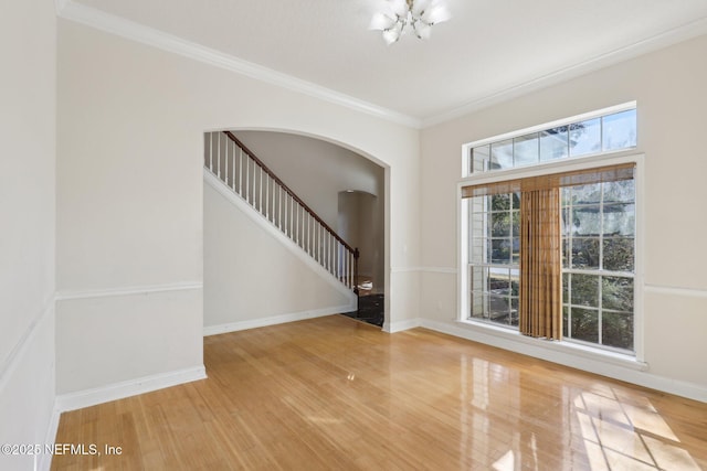 interior space with hardwood / wood-style flooring, crown molding, and a chandelier