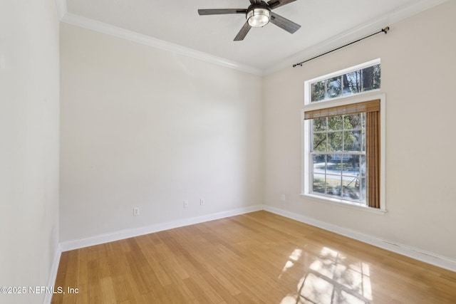 spare room featuring wood-type flooring, ornamental molding, and ceiling fan