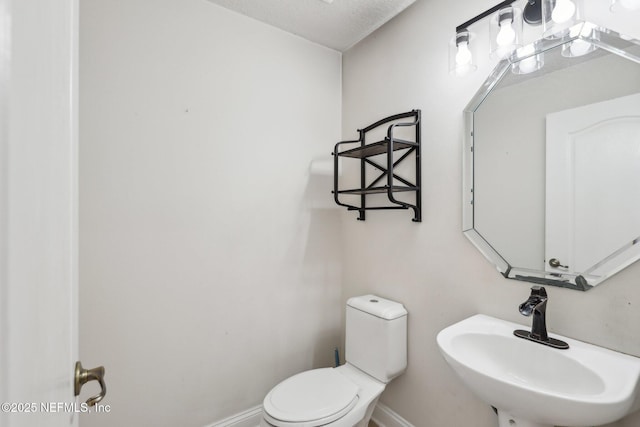 bathroom featuring sink and toilet