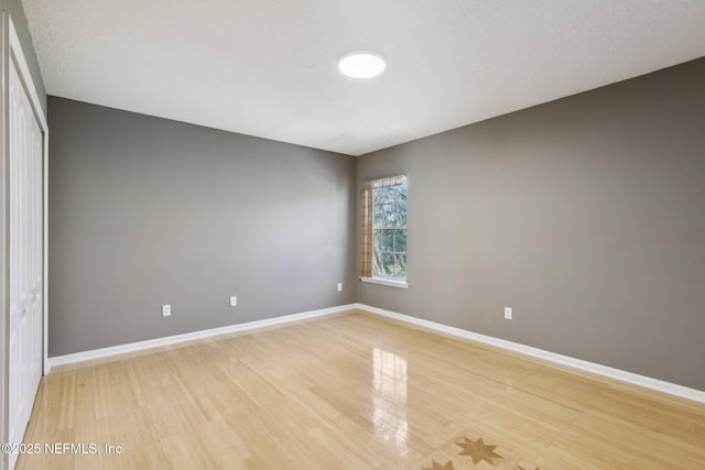 unfurnished room with hardwood / wood-style floors