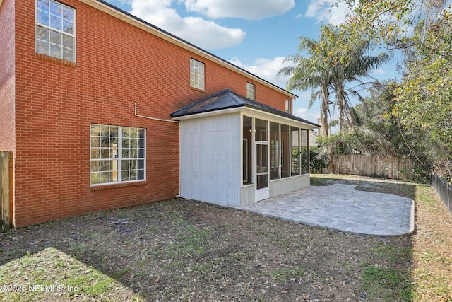 back of property featuring a patio and a sunroom