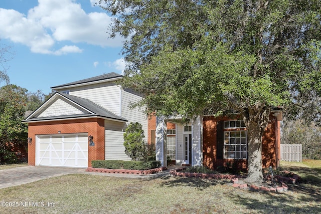 view of front of property featuring a garage and a front yard