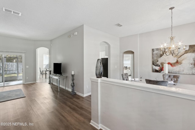 interior space featuring a chandelier, dark hardwood / wood-style floors, and a textured ceiling