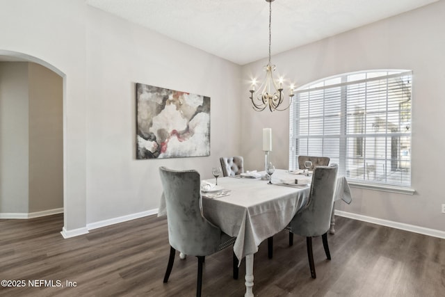 dining area featuring dark hardwood / wood-style floors and a notable chandelier