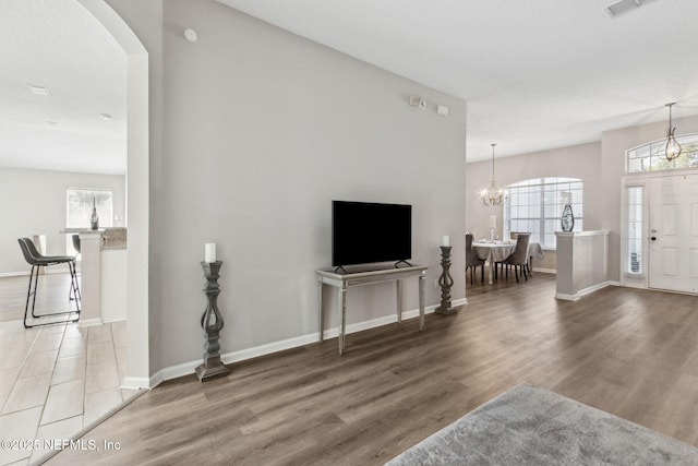 living room featuring wood-type flooring and a chandelier