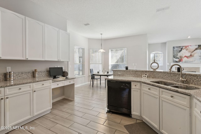 kitchen with sink, black dishwasher, pendant lighting, light stone countertops, and white cabinets