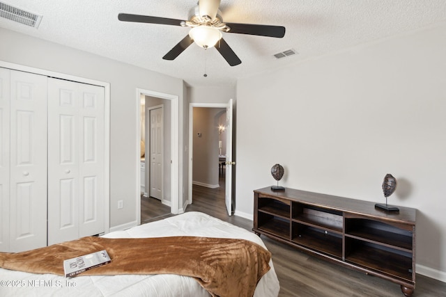 bedroom with ceiling fan, wood-type flooring, a closet, and a textured ceiling