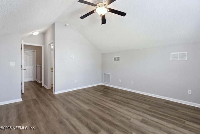 additional living space featuring ceiling fan, dark hardwood / wood-style floors, vaulted ceiling, and a textured ceiling