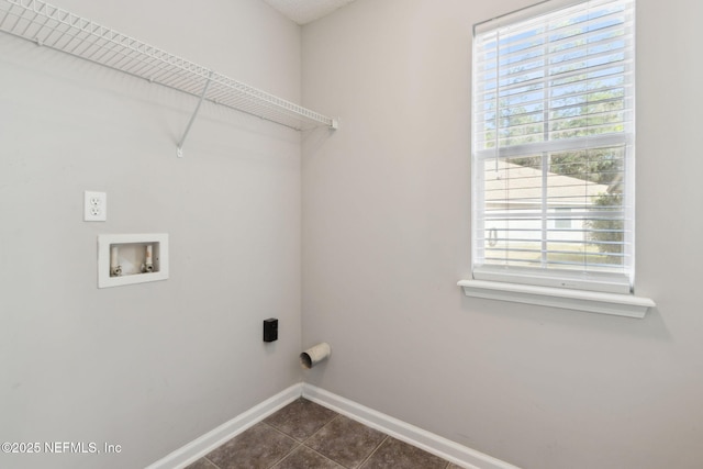 laundry area with dark tile patterned floors and washer hookup