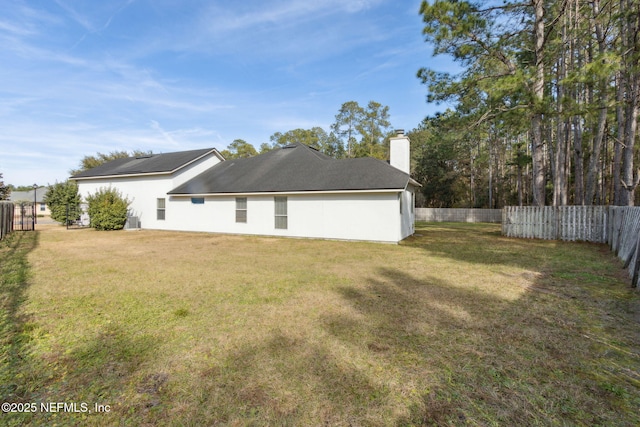 rear view of house with a lawn