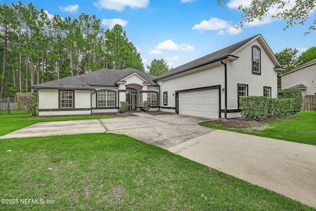 view of front of property featuring a garage and a front yard