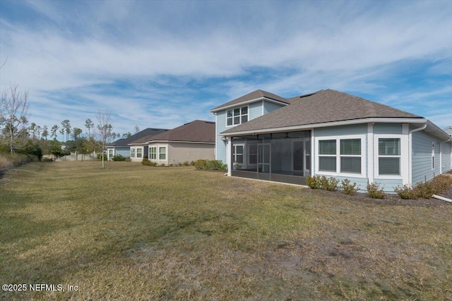 back of property featuring a yard and a sunroom