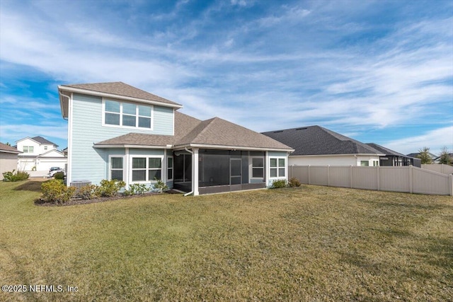 rear view of property featuring a yard and a sunroom