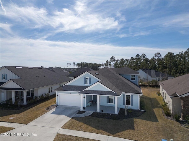 view of front of home featuring a garage, a porch, and a front yard