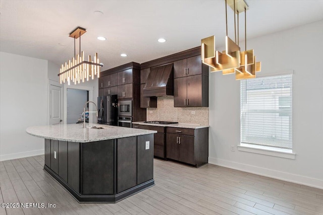 kitchen featuring decorative light fixtures, stainless steel appliances, dark brown cabinetry, and premium range hood