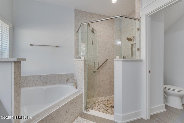 bathroom with shower with separate bathtub and toilet