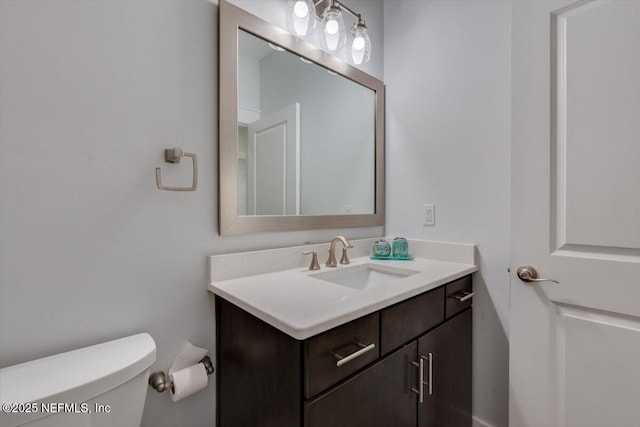 bathroom featuring toilet and vanity