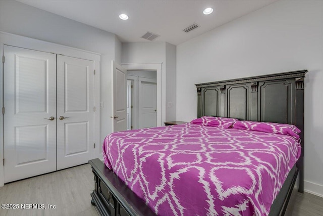 bedroom featuring light hardwood / wood-style floors and a closet