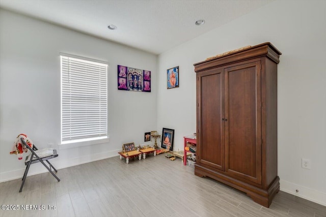 game room featuring light wood-type flooring