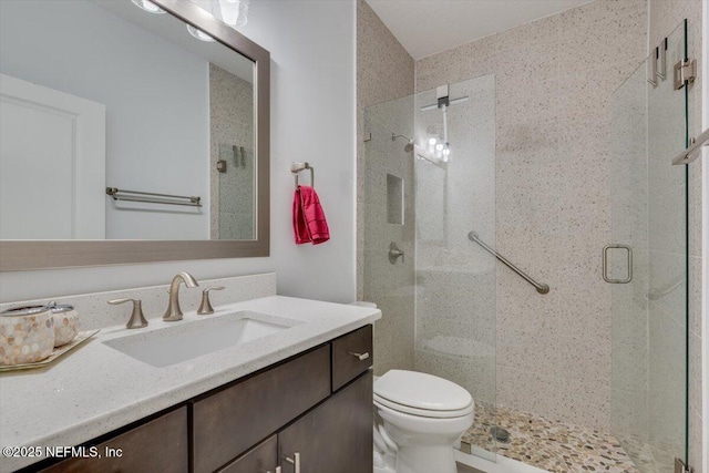 bathroom with vanity, toilet, and walk in shower