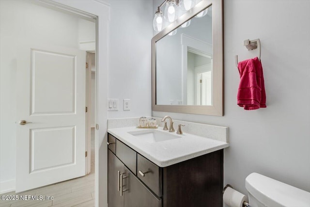 bathroom with toilet and vanity