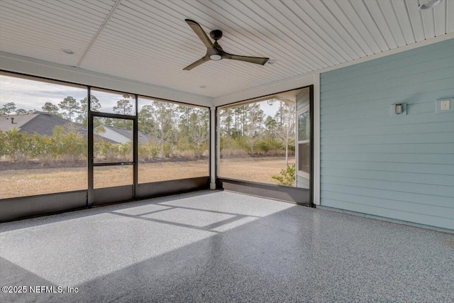 unfurnished sunroom featuring ceiling fan