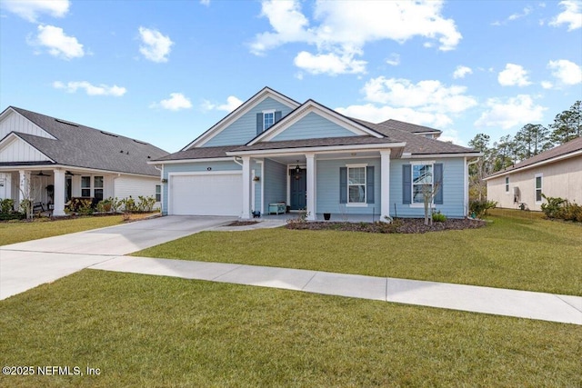 view of front of property featuring a garage, a porch, and a front yard