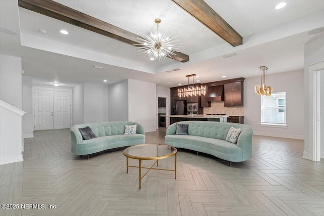 living room with beam ceiling, light parquet flooring, a raised ceiling, and a chandelier