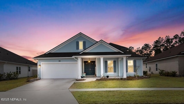 view of front of house with a garage and a lawn