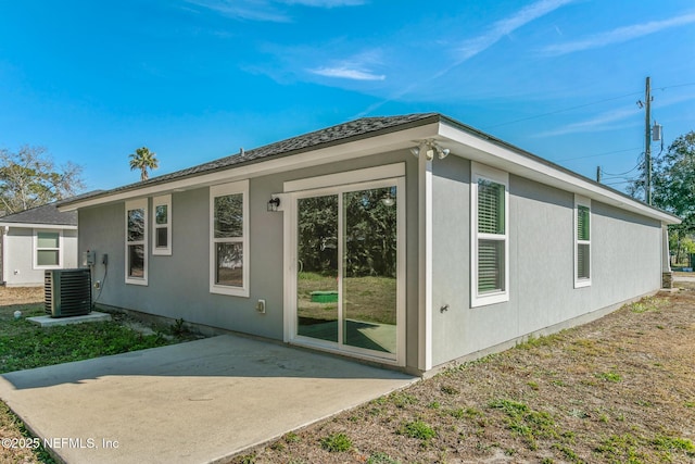 view of side of property featuring central AC unit and a patio area