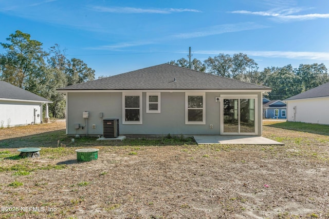 rear view of house with central AC and a patio area