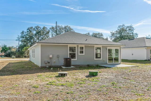 rear view of house with a patio and central AC