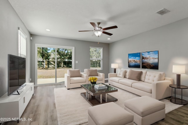 living room with ceiling fan and light hardwood / wood-style floors