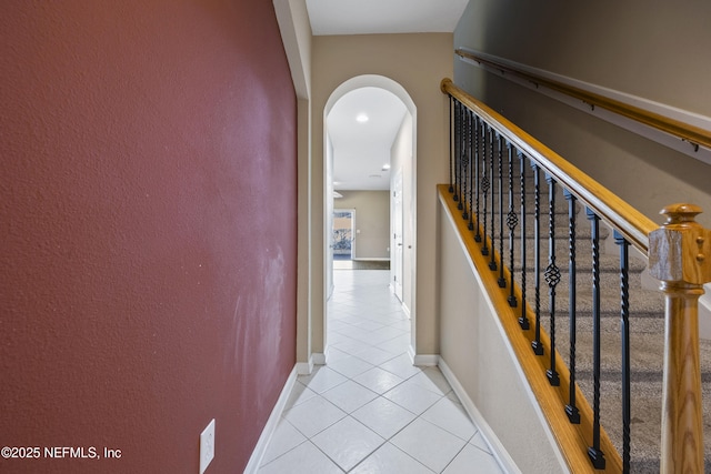 staircase featuring tile patterned flooring