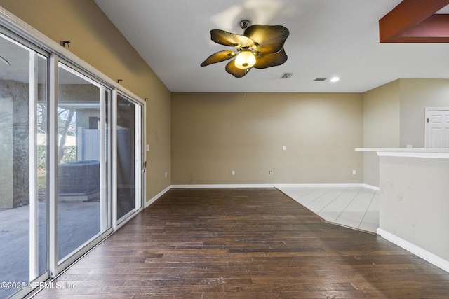 unfurnished room featuring dark hardwood / wood-style flooring and ceiling fan